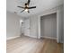 Bright bedroom featuring a ceiling fan, wood floors and a closet with sliding doors at 341 Se 53Rd Ct, Ocala, FL 34480