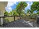 Deck overlooking the backyard, accented by trees and sky at 341 Se 53Rd Ct, Ocala, FL 34480