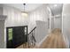 Hallway with wood flooring, wrought iron railing and a decorative chandelier at 341 Se 53Rd Ct, Ocala, FL 34480