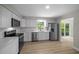 Modern kitchen boasts stainless steel appliances, white cabinets, and a view to the backyard at 341 Se 53Rd Ct, Ocala, FL 34480