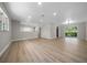 Spacious open-concept living area with wood flooring, neutral tones, and sliding glass doors to deck at 341 Se 53Rd Ct, Ocala, FL 34480
