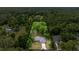 Expansive aerial view shows property, surrounded by lush greenery and mature trees, offering privacy at 5118 Sw 197Th Ter, Dunnellon, FL 34431