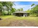 Backyard featuring a screened-in porch, grill and tree coverage at 5118 Sw 197Th Ter, Dunnellon, FL 34431