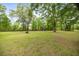 Expansive backyard featuring mature trees, green grass, fire pit and a playset at 5118 Sw 197Th Ter, Dunnellon, FL 34431