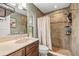 Well-lit bathroom showcasing tile shower with sleek fixtures, a modern sink, and a toilet at 5118 Sw 197Th Ter, Dunnellon, FL 34431