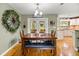Inviting dining room with hardwood floors, a wooden table, and backyard view at 5118 Sw 197Th Ter, Dunnellon, FL 34431