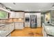 Well-equipped kitchen features custom cabinetry, stainless steel appliances, and granite countertops at 5118 Sw 197Th Ter, Dunnellon, FL 34431