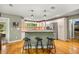 Modern kitchen with white cabinetry, granite countertops, stainless steel appliances, and breakfast bar at 5118 Sw 197Th Ter, Dunnellon, FL 34431