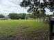 View of a large grassy yard next to a wooden fence at 6020 Nw 2Nd Ave, Ocala, FL 34475
