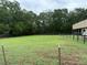 Lush, fenced green property providing a private and secure outdoor area, surrounded by mature trees at 6020 Nw 2Nd Ave, Ocala, FL 34475