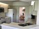 Kitchen features appliances, bright white cabinets, and a view into the dining room at 9224 Sw 91St Cir, Ocala, FL 34481