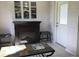 Cozy living area featuring a decorative fireplace and comfortable seating at 9224 Sw 91St Cir, Ocala, FL 34481