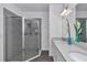Modern bathroom featuring a glass-enclosed shower, dual vanities, and elegant finishes at 9312 Sw 58Th Cir, Ocala, FL 34476