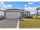 Charming single-story home featuring a two-car garage, manicured lawn, and a welcoming entrance at 9312 Sw 58Th Cir, Ocala, FL 34476