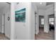 Inviting hallway featuring modern artwork and neutral tones, creating a serene and stylish transition space at 9312 Sw 58Th Cir, Ocala, FL 34476