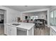 Open kitchen layout with stainless steel appliances, quartz countertops, and a large kitchen island at 9312 Sw 58Th Cir, Ocala, FL 34476