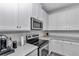 Modern kitchen with white cabinets, stainless steel appliances and plenty of counter space at 9312 Sw 58Th Cir, Ocala, FL 34476