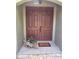 Charming entryway featuring double doors, a 'Welcome' mat, and a decorative planter, creating a warm invitation at 35 Lake Wood Cir, Ocala, FL 34482