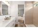 Modern bathroom with double vanity, ceramic tile shower, stylish fixtures and view into neutral bedroom at 36 Pine Radl, Ocala, FL 34472