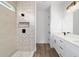 Bright bathroom featuring a glass shower with ceramic tile surround, modern fixtures and double vanity at 36 Pine Radl, Ocala, FL 34472