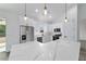 Modern kitchen with stainless steel appliances, a sleek island, and pendant lighting at 36 Pine Radl, Ocala, FL 34472