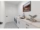 Well-appointed laundry room with modern appliances, custom cabinetry, countertop, and stylish ceramic tile flooring at 36 Pine Radl, Ocala, FL 34472