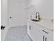 Bright laundry room featuring patterned tile floor, white cabinets, and modern fixtures at 36 Pine Radl, Ocala, FL 34472