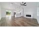 Bright living room area with a sleek fireplace, fan, and open layout into the kitchen at 36 Pine Radl, Ocala, FL 34472