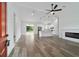 Open-concept living room with a modern fireplace and sliding glass doors to the backyard at 36 Pine Radl, Ocala, FL 34472