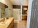 Functional bathroom featuring a shower with sliding doors, double sinks, and a well lit vanity at 9053 Sw 103Rd Ave, Ocala, FL 34481