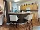 The kitchen has light wood cabinets and countertop seating open to the living room at 9053 Sw 103Rd Ave, Ocala, FL 34481