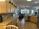 Kitchen featuring light wood cabinets, tile backsplash, and modern appliances with an open floor plan at 9053 Sw 103Rd Ave, Ocala, FL 34481