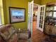 Sitting area with large painting and doors leading into living room with comfortable seating at 9053 Sw 103Rd Ave, Ocala, FL 34481
