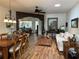 Open-concept living room with a dining table and inviting furnishings, bathed in natural light from the skylight at 9053 Sw 103Rd Ave, Ocala, FL 34481