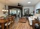 Open-concept living room with a dining table and inviting furnishings, bathed in natural light from the skylight at 9053 Sw 103Rd Ave, Ocala, FL 34481