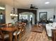 Open-concept living room with a dining table and inviting furnishings, bathed in natural light from the skylight at 9053 Sw 103Rd Ave, Ocala, FL 34481