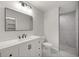 Modern bathroom with white vanity, large mirror, and a walk-in shower with marble-style tile at 14390 Sw 30 Pl, Ocala, FL 34481