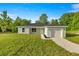 Inviting single-story home featuring a well-manicured lawn and an attached one-car garage at 14390 Sw 30 Pl, Ocala, FL 34481