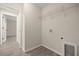 Functional laundry room with tile flooring and convenient storage solutions at 14390 Sw 30 Pl, Ocala, FL 34481