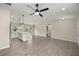 Open-concept living room with a ceiling fan, stylish flooring, and a kitchen island at 14390 Sw 30 Pl, Ocala, FL 34481