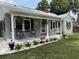 Charming home featuring a welcoming front porch with rocking chairs and decorative plants at 308 Ne 12Th Ave, Ocala, FL 34470