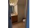 Bathroom featuring wood vanity, tile flooring, toilet, and mirror at 4853 Sw 53Rd Rd, Ocala, FL 34474