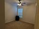 Bedroom with carpet floor, ceiling fan, window with blinds and a black storage unit at 4853 Sw 53Rd Rd, Ocala, FL 34474