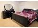 Bright bedroom showcasing a dark-wood dresser with a full mirror and a comfortable bed at 4853 Sw 53Rd Rd, Ocala, FL 34474