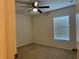Bedroom with neutral walls, carpet flooring, a ceiling fan, and a window with blinds at 4853 Sw 53Rd Rd, Ocala, FL 34474