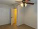 Bedroom with carpet flooring, a ceiling fan with lighting, and double door closet at 4853 Sw 53Rd Rd, Ocala, FL 34474
