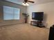 Cozy bedroom features a ceiling fan, large window, and plush carpeting, perfect for relaxation at 4853 Sw 53Rd Rd, Ocala, FL 34474
