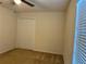 Bedroom with ceiling fan, carpet, window with blinds, and closet with bi-fold doors at 4853 Sw 53Rd Rd, Ocala, FL 34474