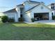 Charming home with a two-car garage, landscaping, and a green lawn at 4853 Sw 53Rd Rd, Ocala, FL 34474