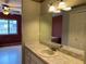 This bathroom has a large mirror above the sink, a faux marble countertop, and access to the bedroom at 5024 Se 109Th St, Belleview, FL 34420